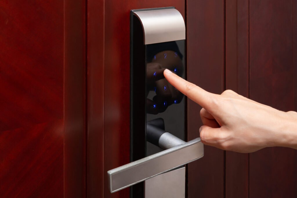 lady inputing passwords on an electronic door lock